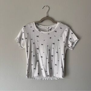 White top with blue floral print